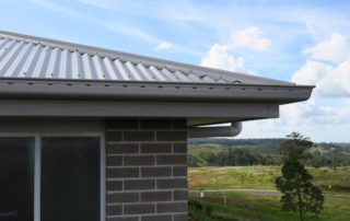 House roofline against countryside backdrop