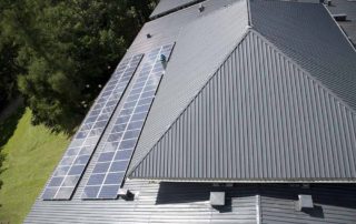 solar panels on a dark grey metal roof