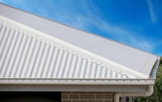 close up view of a white metal roof with visible screws or rivets